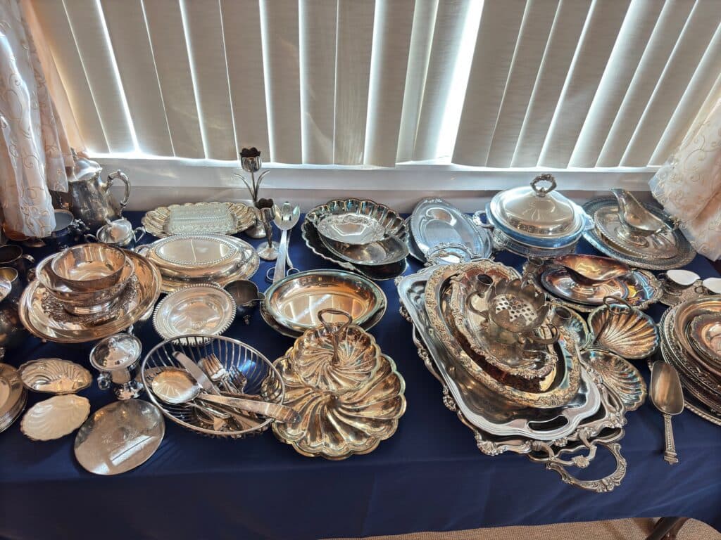 An Estate Greats display of gleaming silver serving pieces