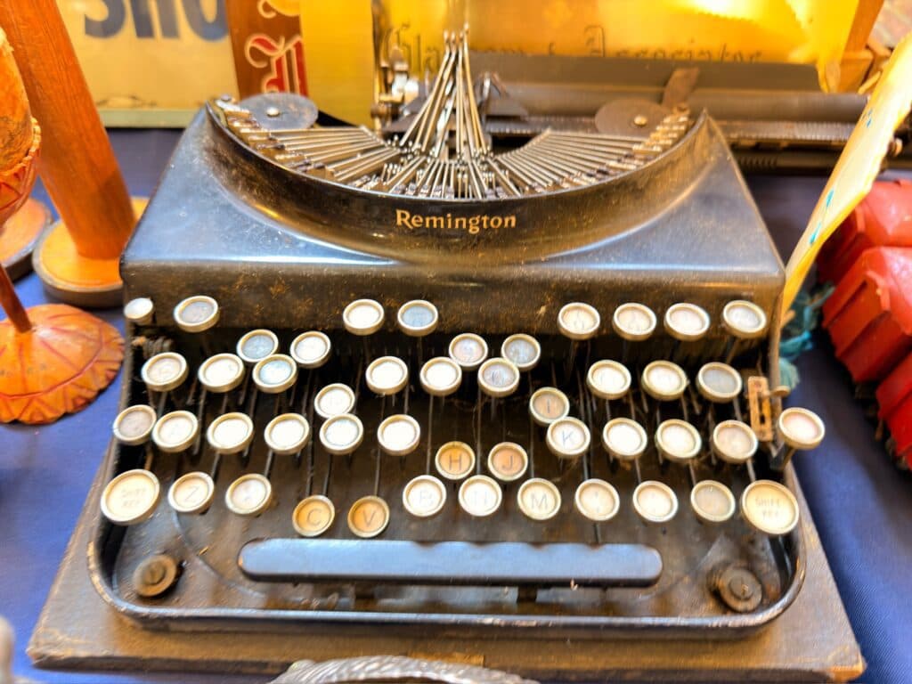 Vintage black typewriter with round cream keys at an Estate Greats sale