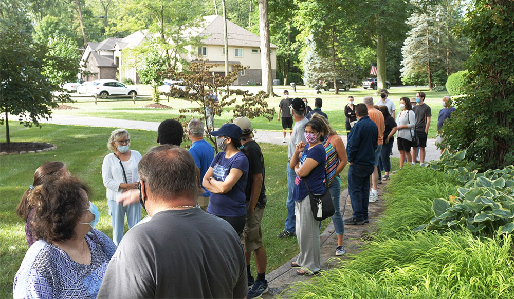 Shoppers lined up outside a home waiting for an Estate Greats sale to open