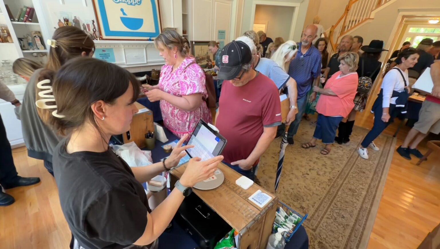 Estate Greats team recording purchases at checkout